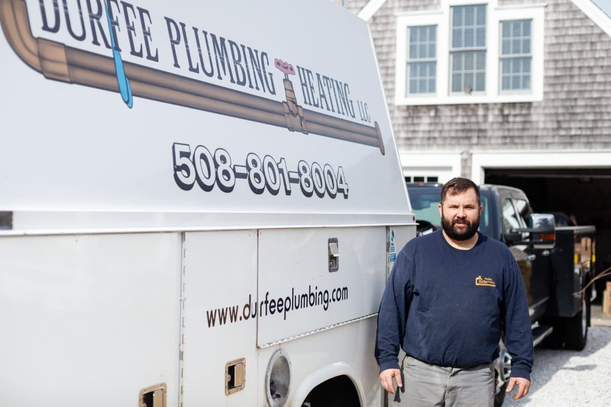 Phil Durfee standing beside a Durfee Plumbing and Heating service truck.