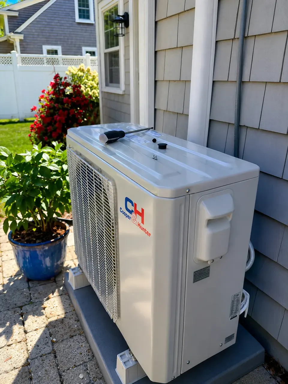 AI-enhanced image of a Cooper and Hunter outdoor mini-split unit beside shingle siding
