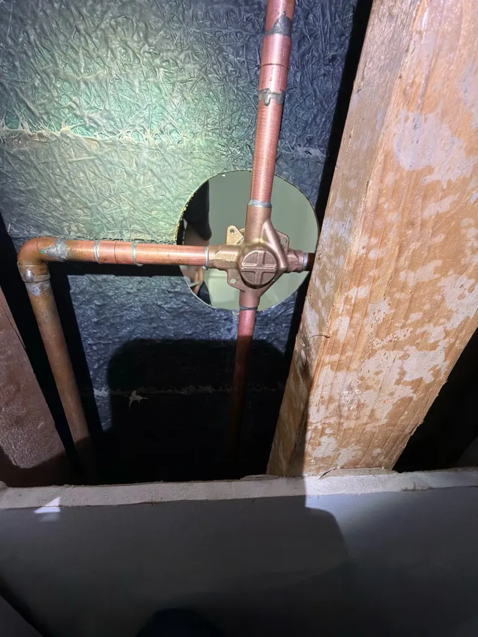 Shower valve and copper supply piping behind an access opening