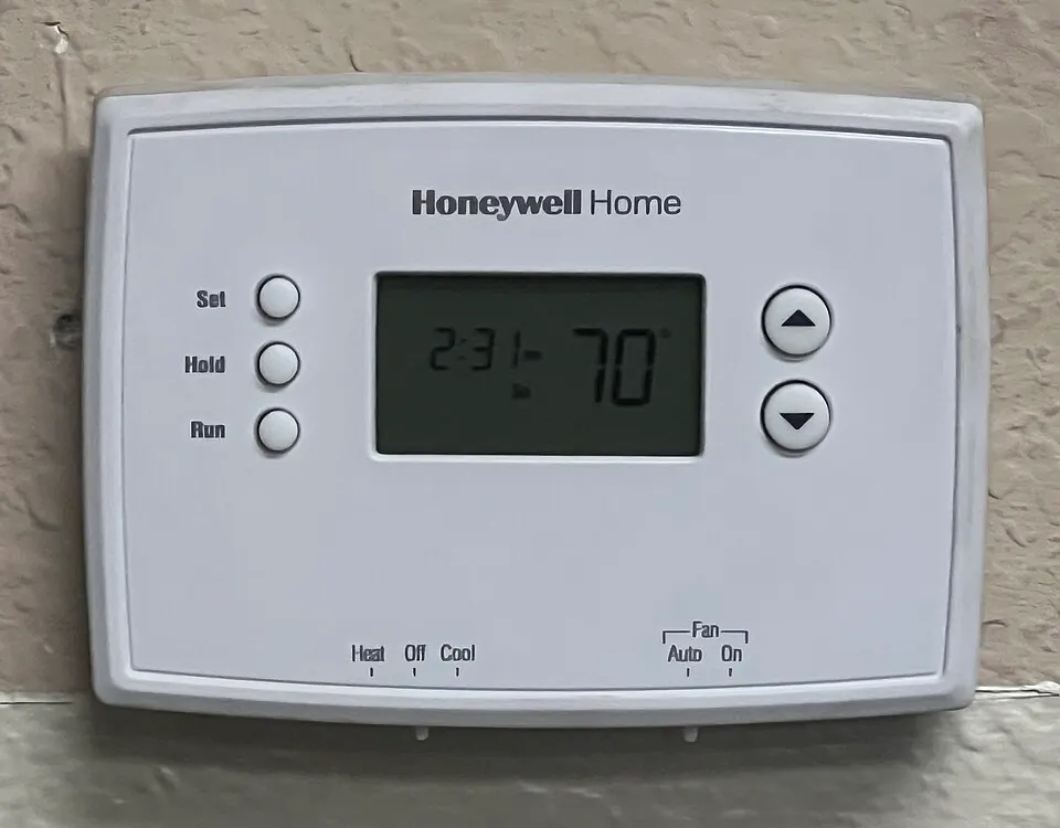 Honeywell Home digital wall thermostat with temperature display and heating and cooling controls
