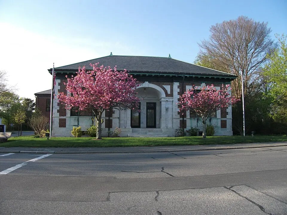 Historic brick building and flowering trees in Harwich, Massachusetts
