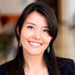 Smiling woman with long dark hair and earrings, representing customer satisfaction and positive testimonials for Durfee Plumbing & Heating LLC.